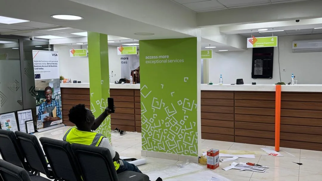 Access Bank banking hall with branded green columns and teller counters
