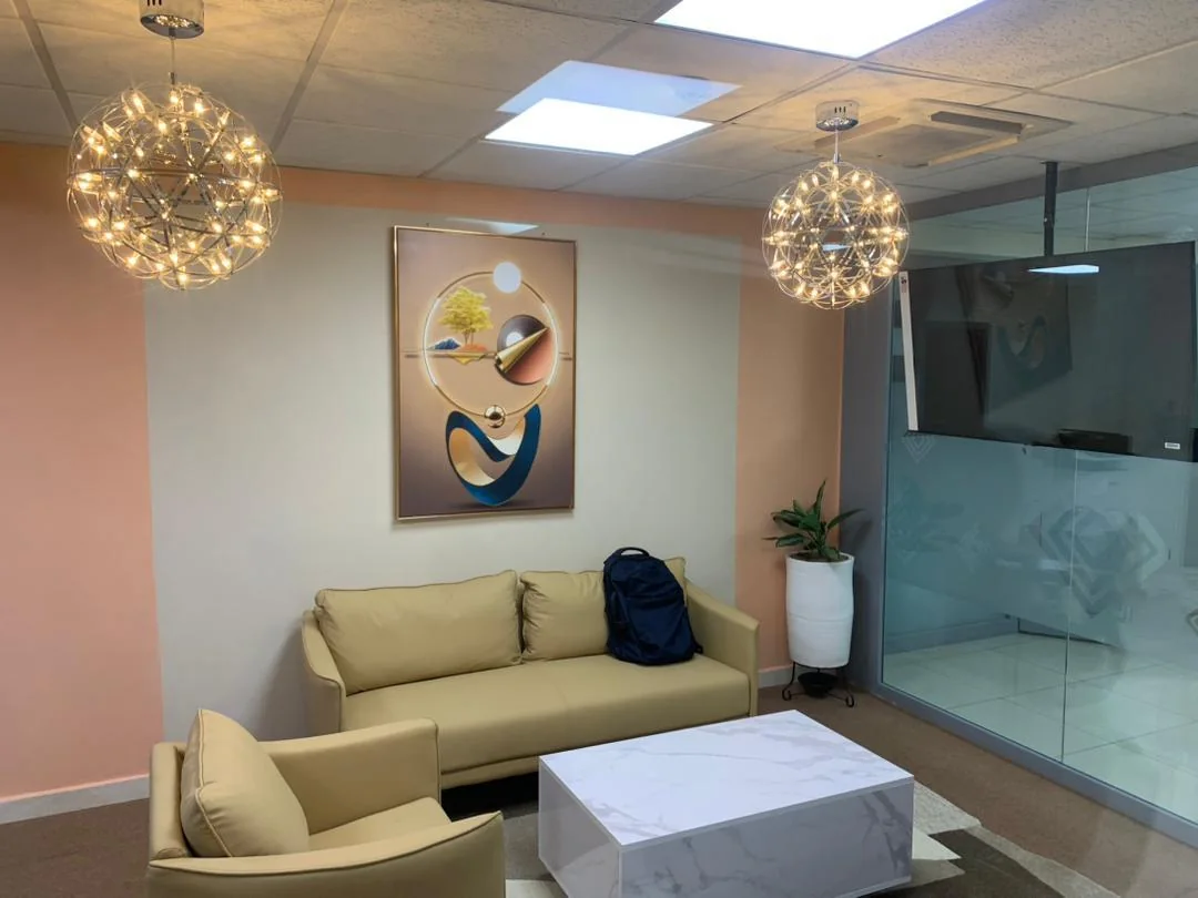 Reception lounge with feature artwork and sculptural pendant lighting